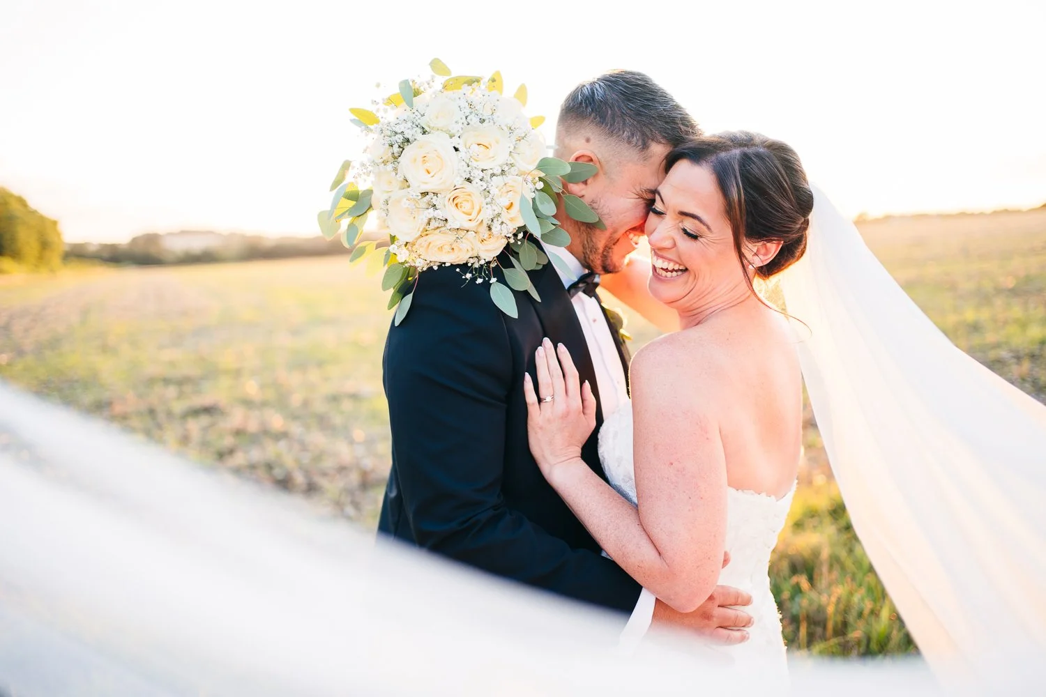 clock-barn-wedding-couple-laughing-at-golden-hour.jpg