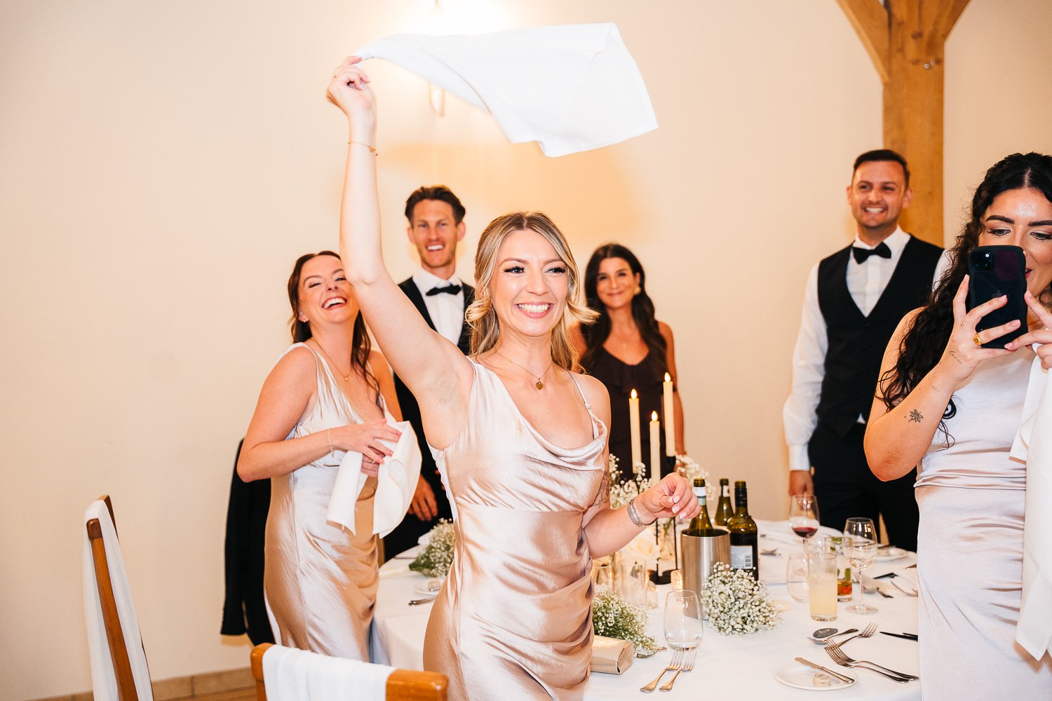 rivervale-barn-berkshire-wedding-couple-entrance-guest-napkin-waving.jpg