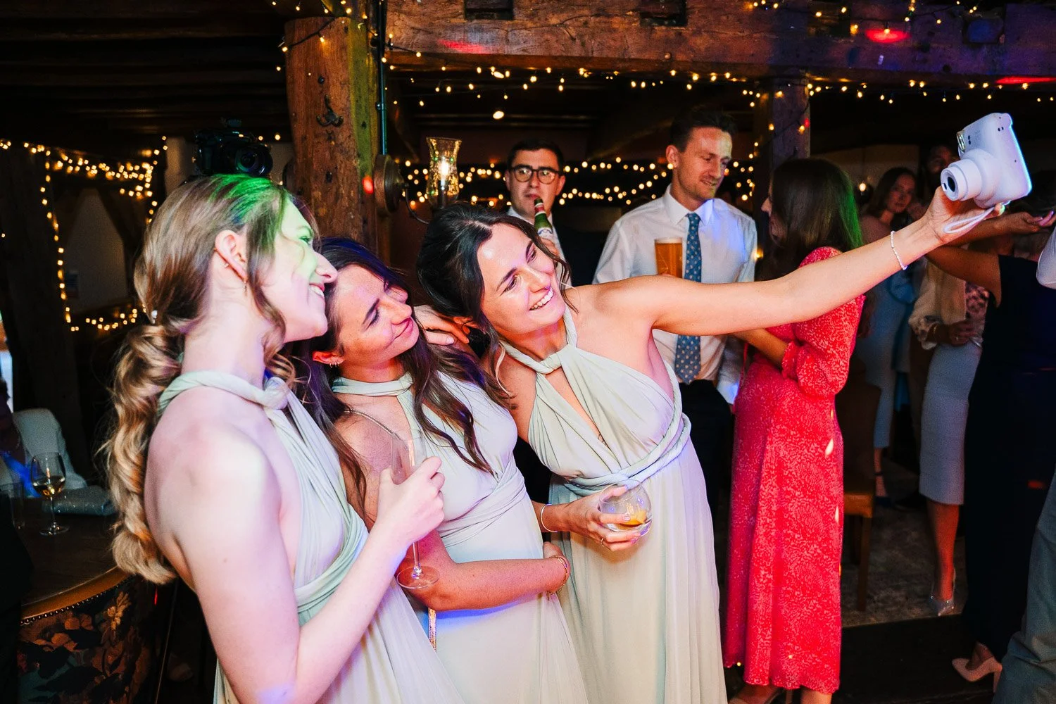 bartons-mill-wedding-bridesmaids-using-polaroid-candid.jpg