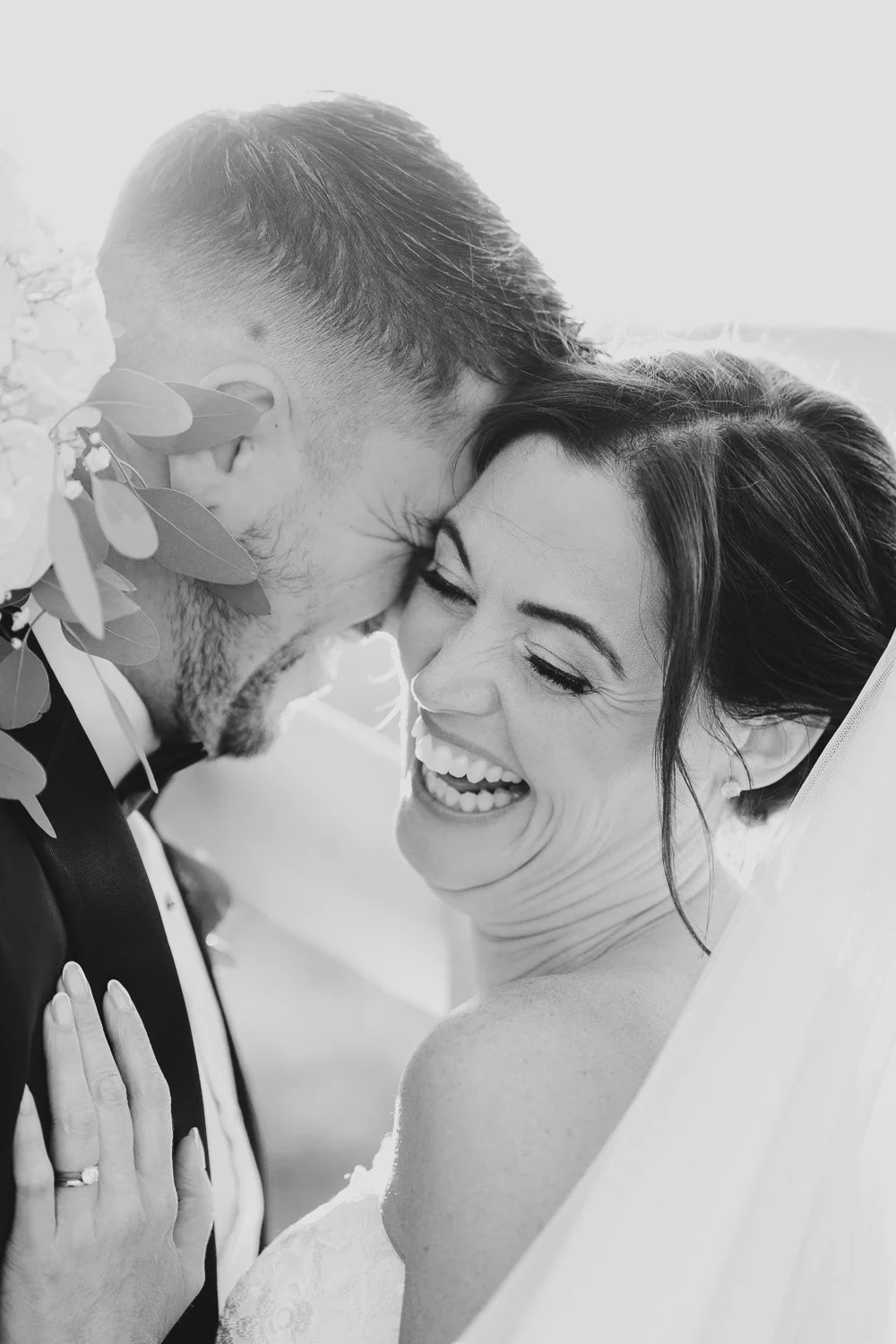 clock-barn-berkshire-wedding-couple-laughing-at-sunset-black-and-white.jpg