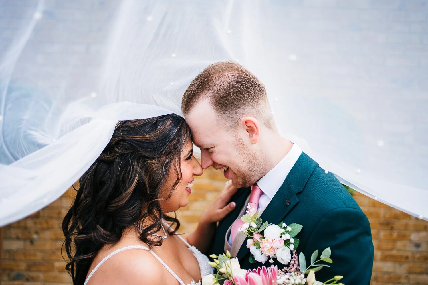kent-wedding-bride-and-groom-under-veil-laughing.jpg