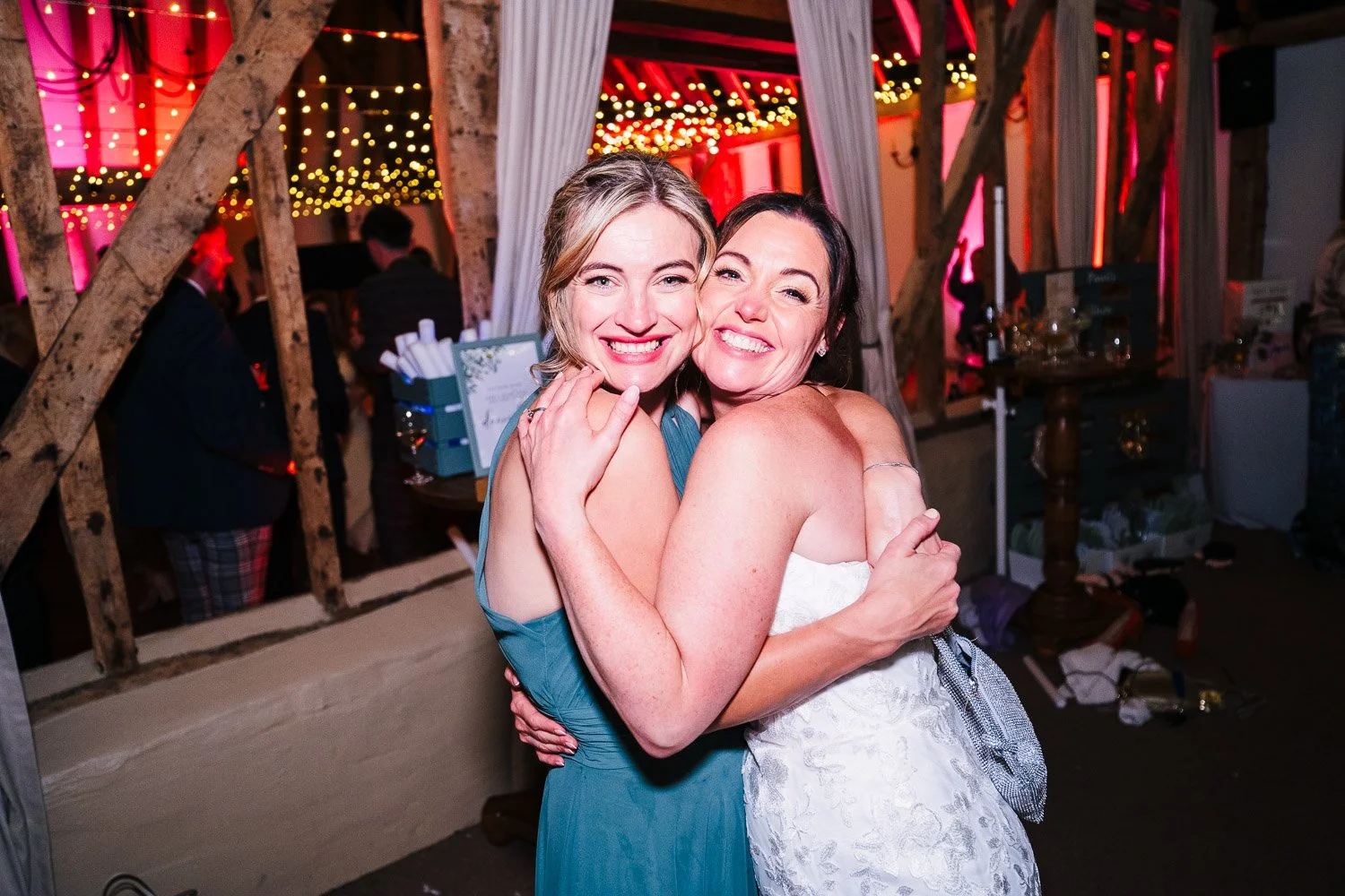 clock-barn-berkshire-wedding-party-bride-and-bridesmaid-hugging.jpg