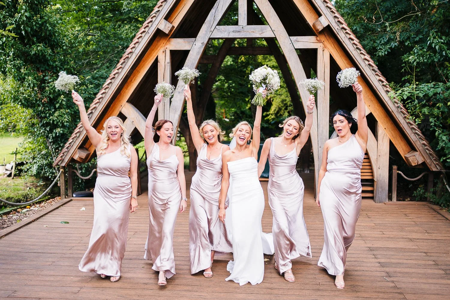 rivervale-barn-berkshire-wedding-bride-and-bridesmaids-bouquets-in-the-air.jpg