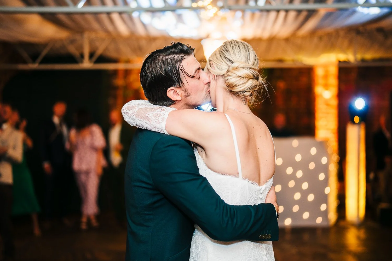 bride-and-groom-first-dance-kiss-on-the-cheek.jpg