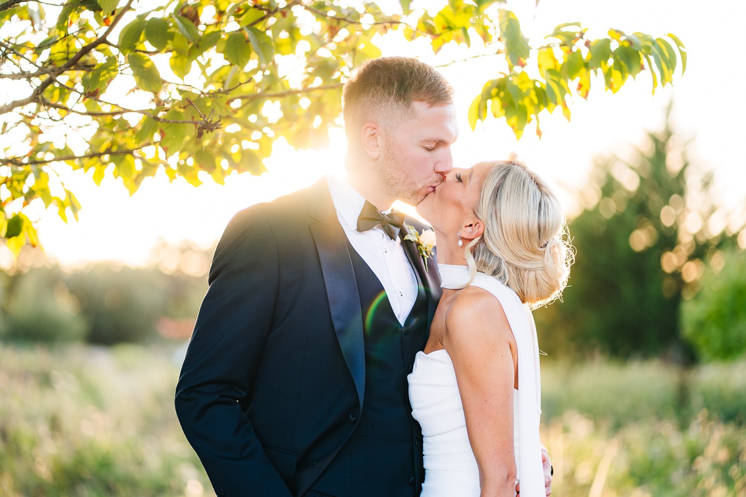 rivervale-barn-wedding-couple-share-a-kiss-at-sunset.jpg
