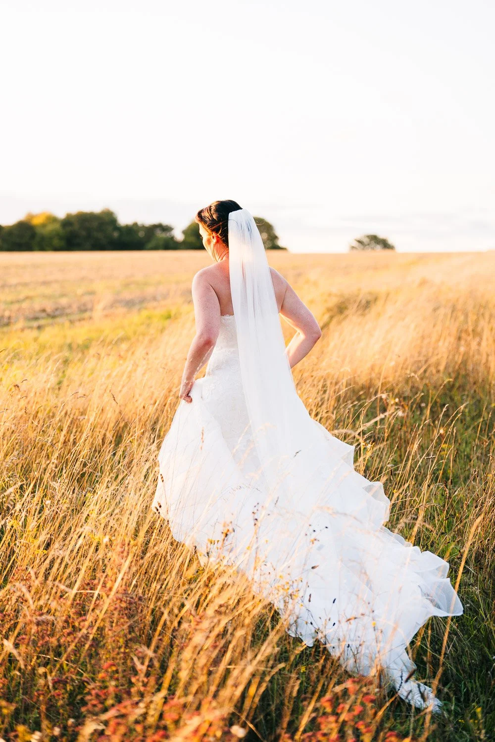 clock-barn-berkshire-wedding-bride-sunset-candid.jpg
