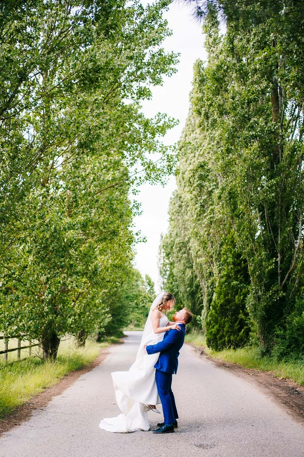 lillibrooke-manor-wedding-groom-lifting-bride-into-the-air.jpg