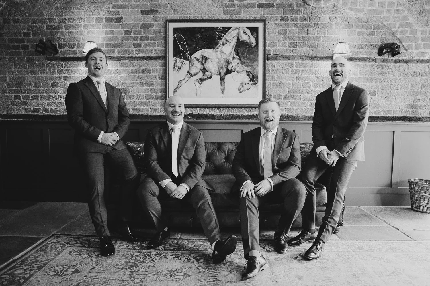 lillibrooke-manor-groomsmen-together-on-couch.jpg