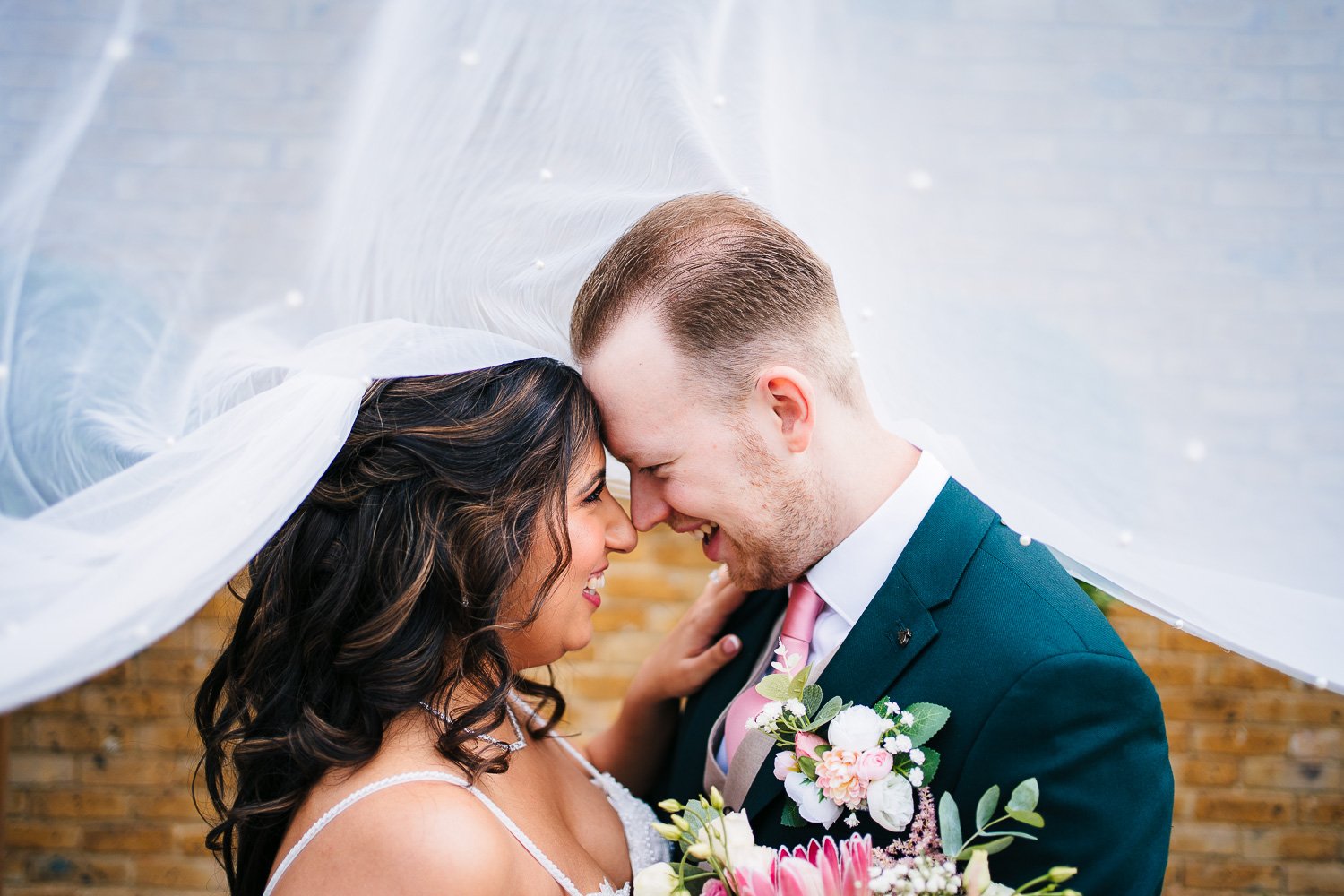 kent-wedding-bride-and-groom-under-veil-laughing.jpg