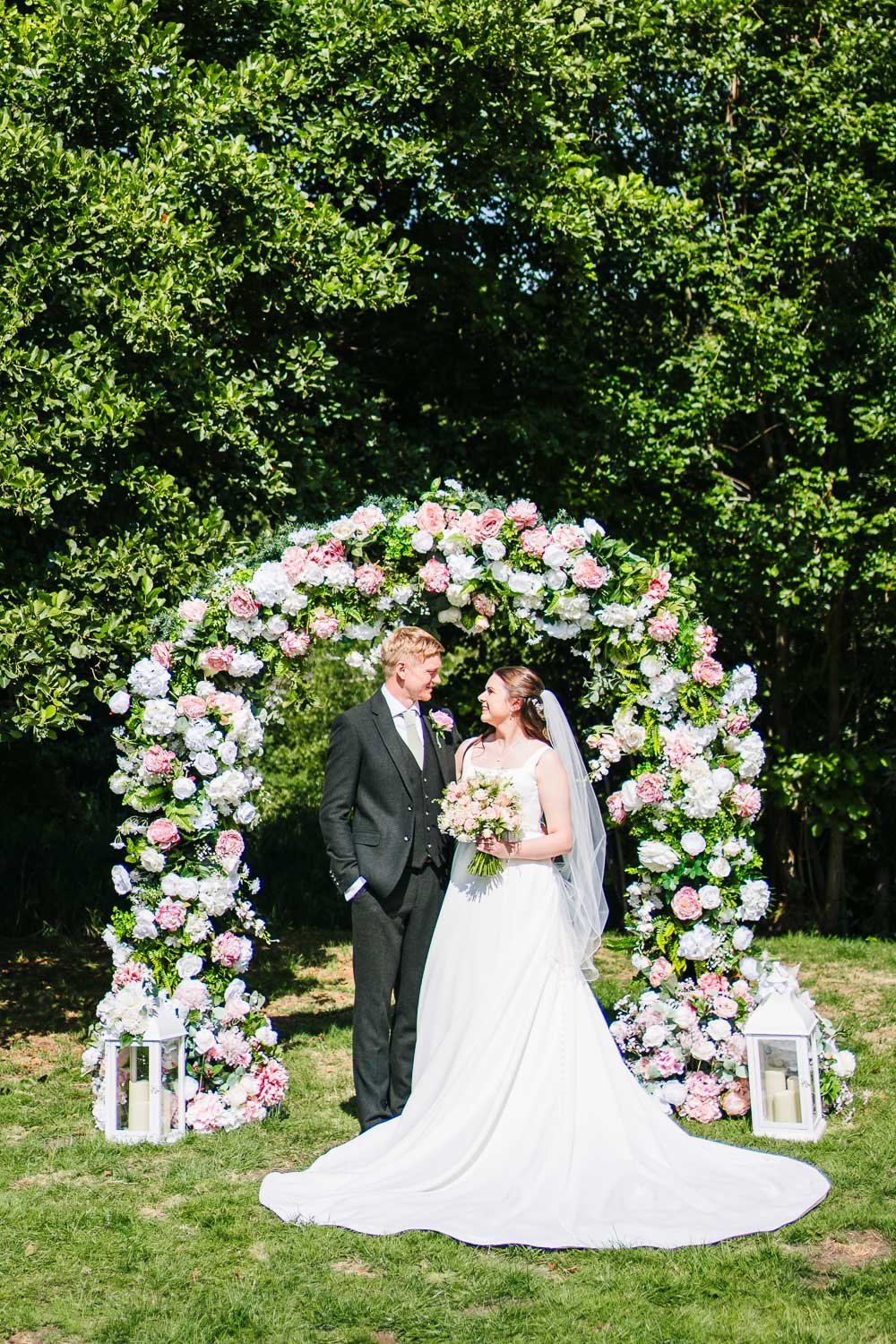 bartons-mill-wedding-couple-with-flower-arch.jpg