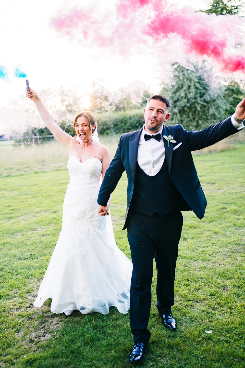 clock-barn-berkshire-wedding-couple-with-smoke-bombs.jpg