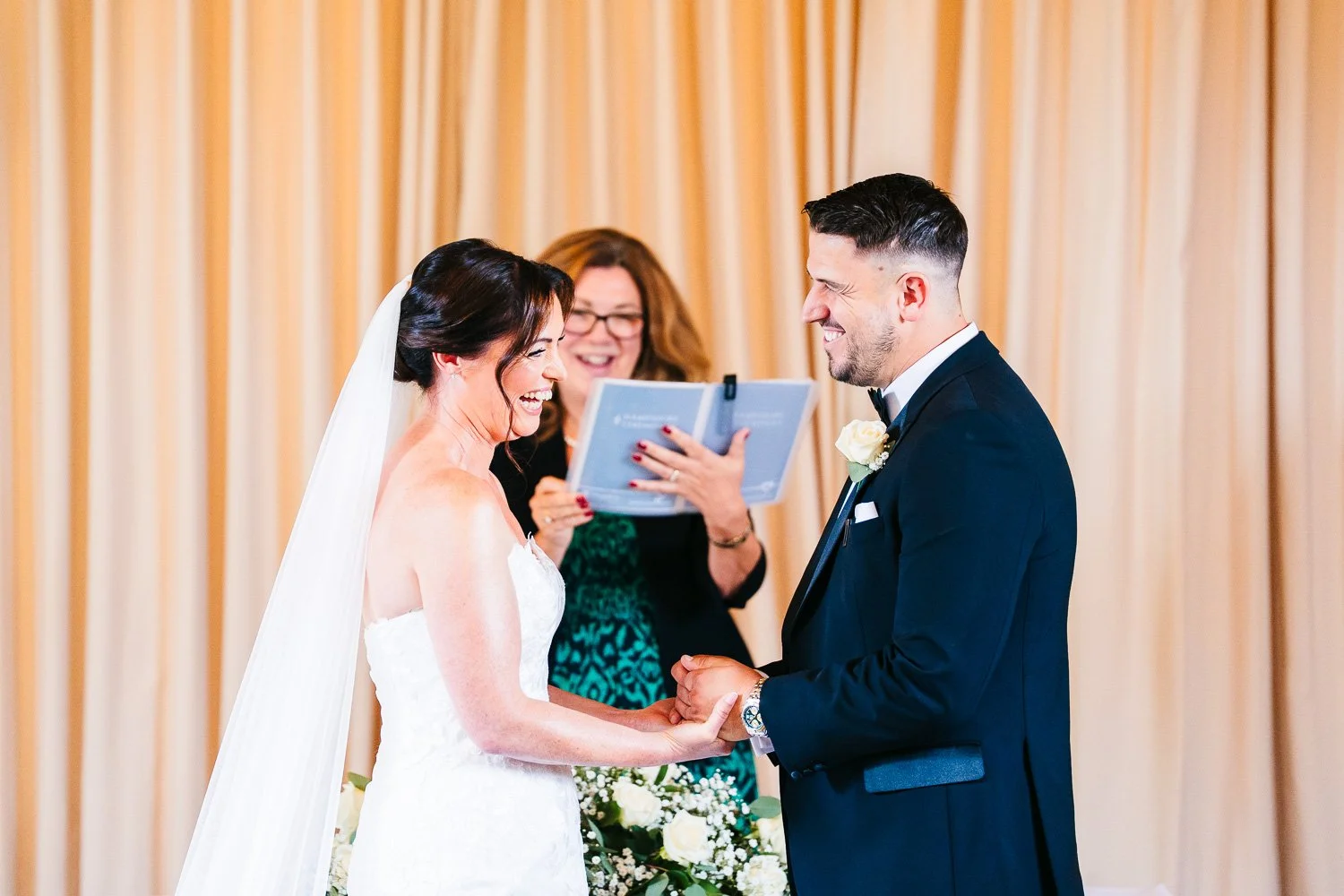 clock-barn-berkshire-wedding-bride-and-groom-laughing-during-the-ceremony.jpg