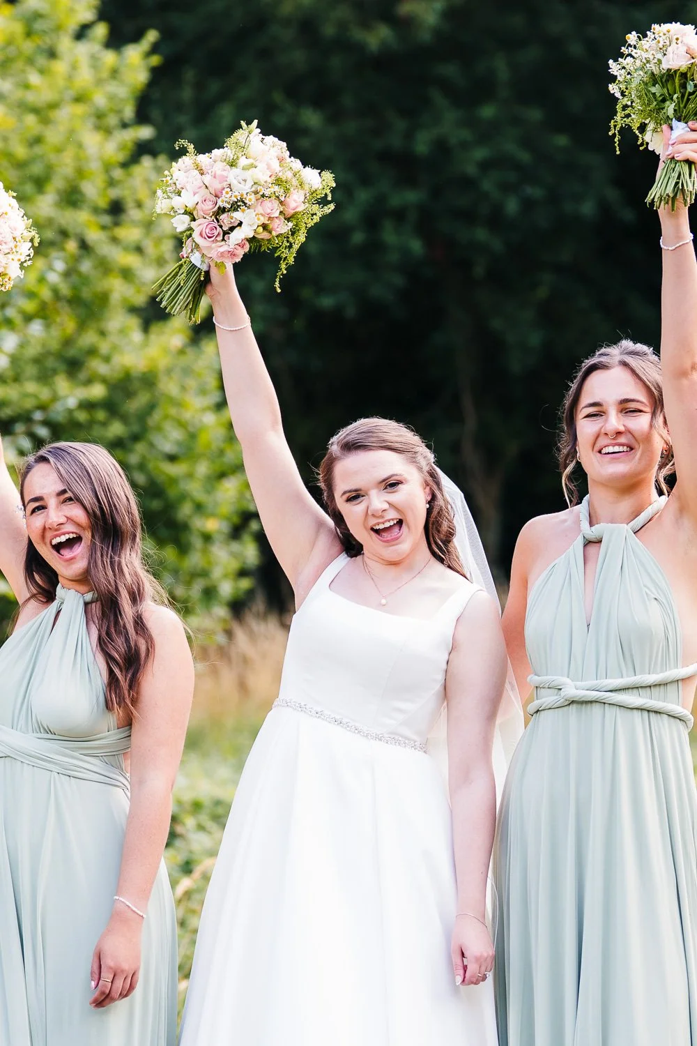 bartons-mill-wedding-bride-with-bouquet-in-air.jpg