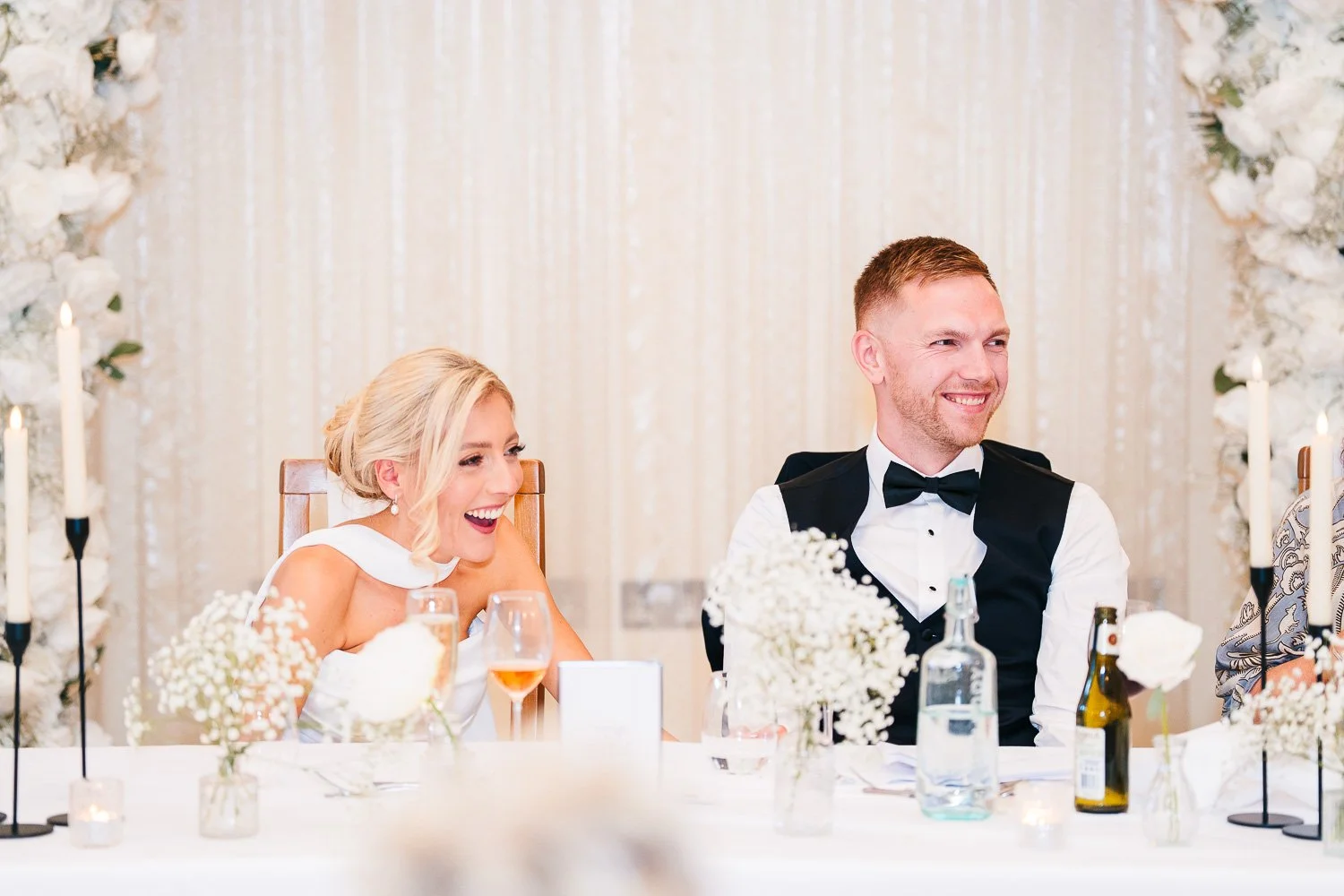 rivervale-barn-berkshire-wedding-bride-and-groom-laughing-at-speech.jpg