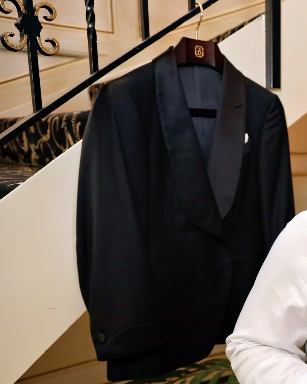 A black shawl collar tuxedo jacket on a Berez hanger on the wedding morning