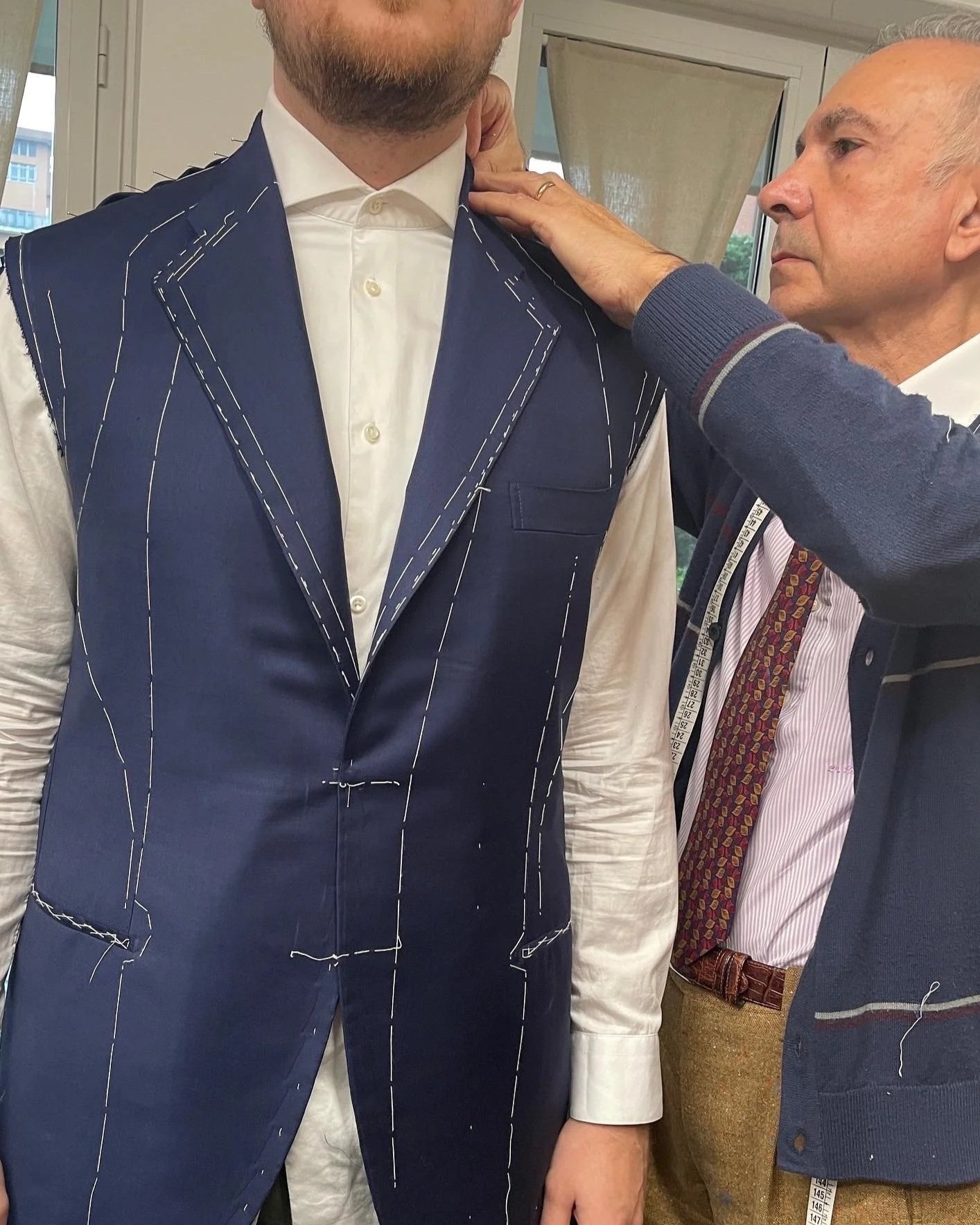 Gus being fitted in a basted jacket during his study in Milan