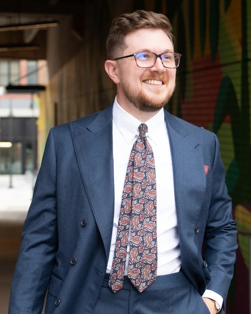 Gus Pagès in a navy double-breasted suit