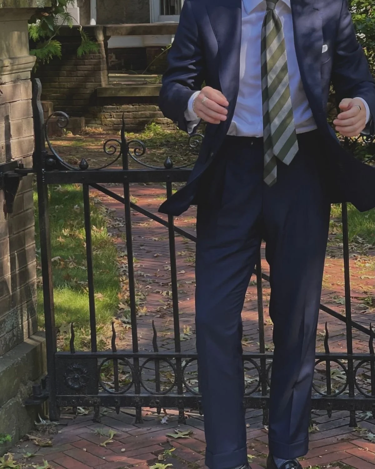 Brandon Ciavarella in a navy two-piece suit with pleated, cuffed trousers
