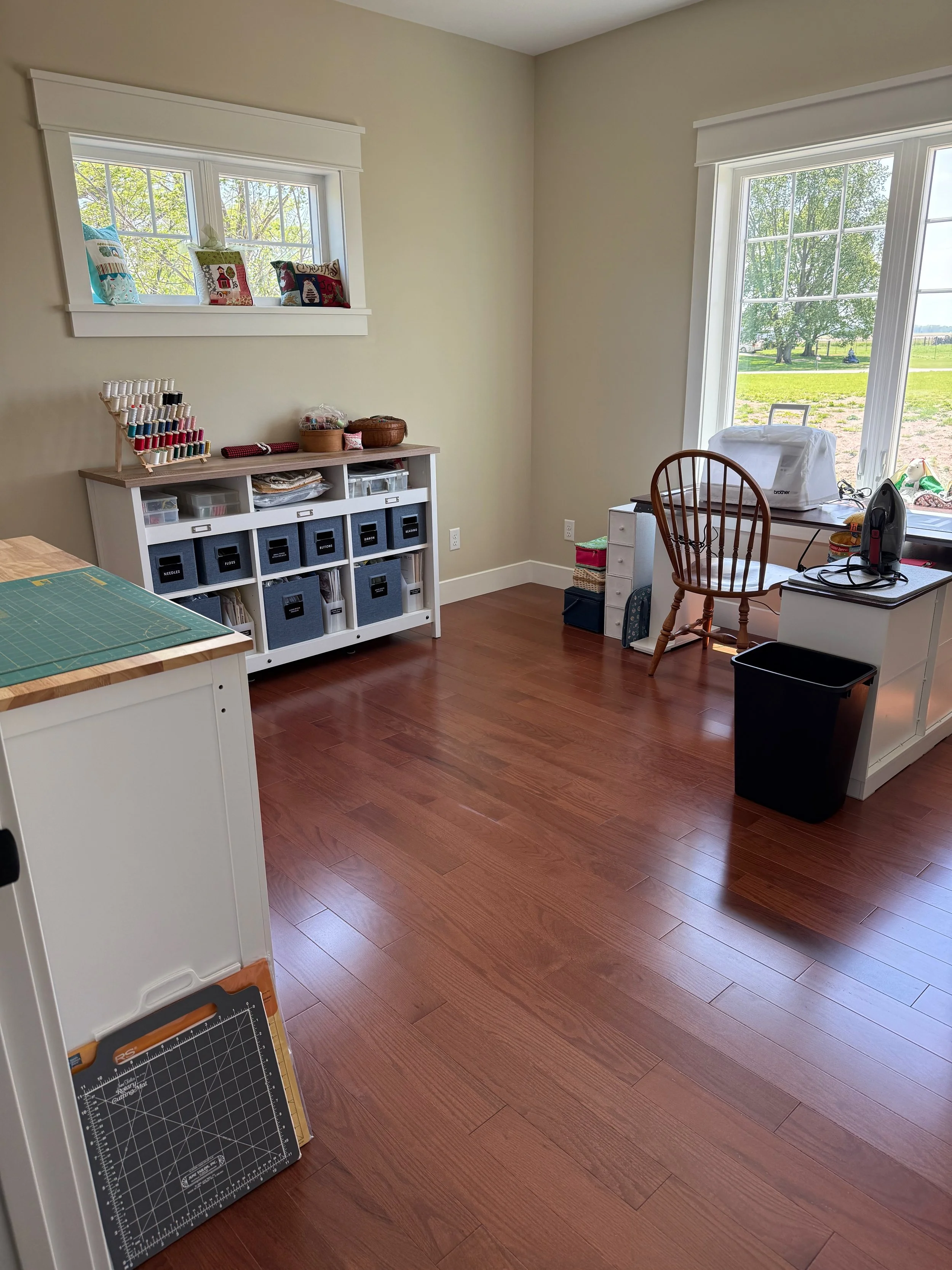 The finished room brings together cutting space, a sewing workstation, and supply storage based on how my client wanted to work.