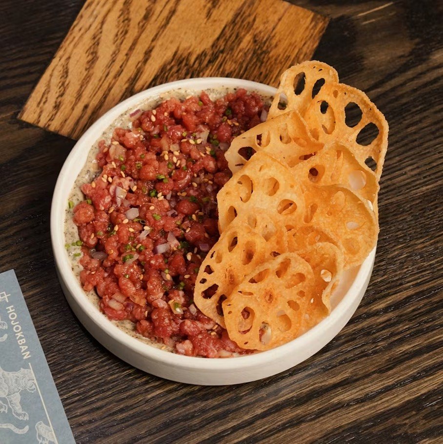 Fresh beef tartare seasoned with soy sauce and seaweed mayo, served with crispy lotus root chips