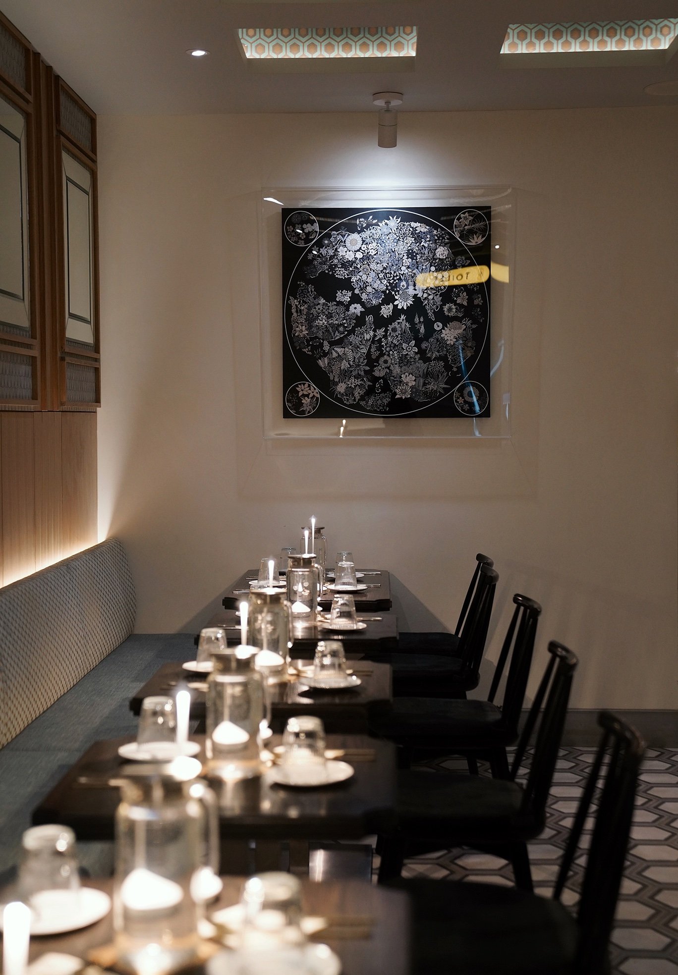 Hojokban NYC interior featuring intimate candlelit dining tables, modern Korean restaurant design, and contemporary wall art in New York City