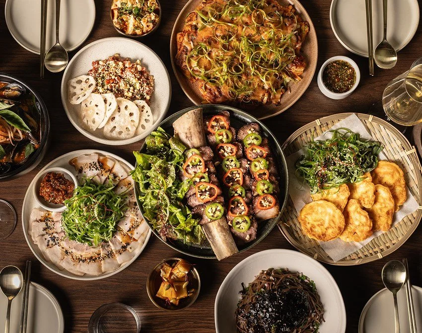 Overhead view of a shared Korean dining table at Hojokban with multiple plated dishes arranged across the table.