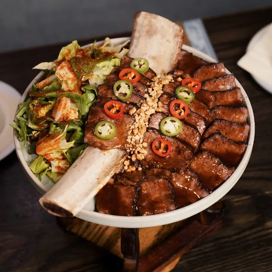Hojok galbi — Korean-style short rib steak with salad, sliced chilis, and crunchy toppings