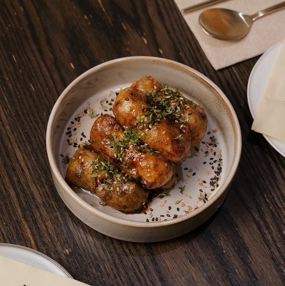 Black garlic eggplant — fried eggplant pieces coated in black garlic sauce with chive, sesame, and thyme