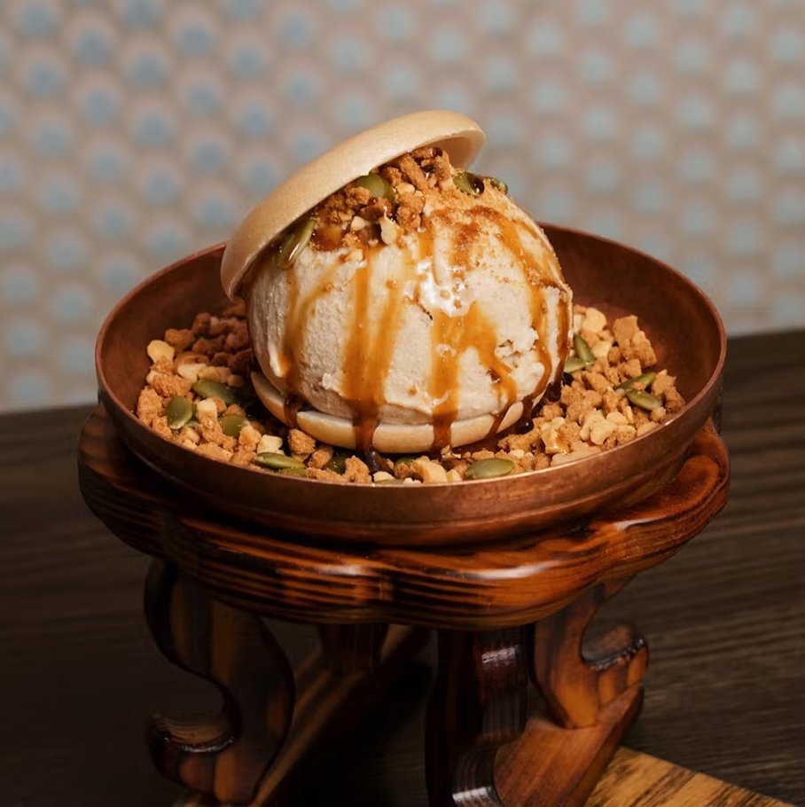 Hotteok ice cream — cinnamon ice cream in a monaka shell with brown sugar syrup, cookie crumbs, pumpkin seeds, and peanuts