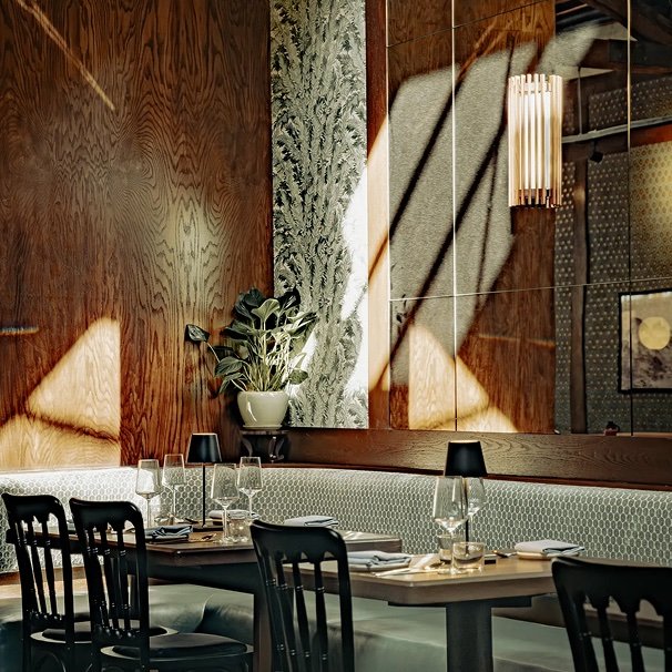 Modern Korean restaurant interior with warm wood paneling, greenery, and intimate dining tables at Hojokban LA