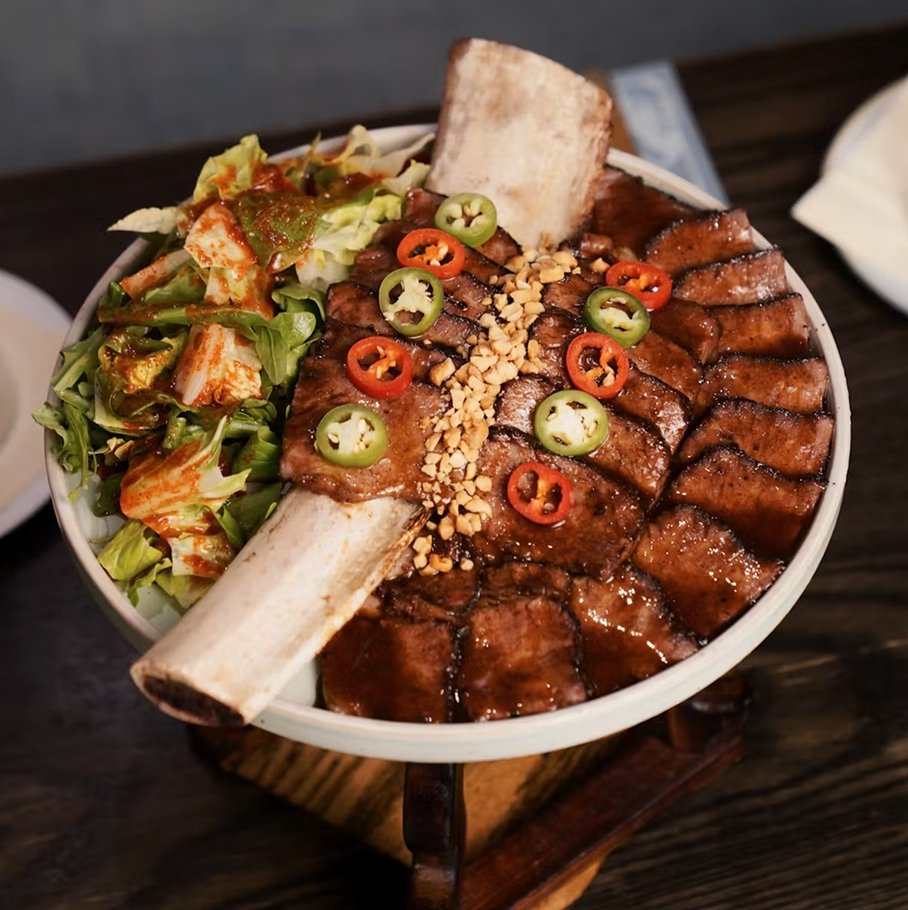 Hojok galbi — Korean-style short rib steak with salad, sliced chilis, and crunchy toppings