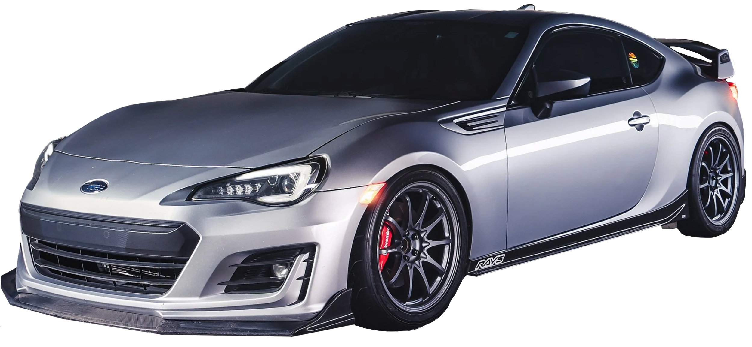 Metallic silver sports car with black wheels, red brake calipers, and aerodynamic features, viewed from the front and side.