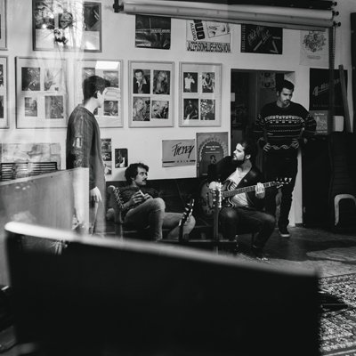 Rene Jesser and Band working together in recording room to figure out how the song should sound.