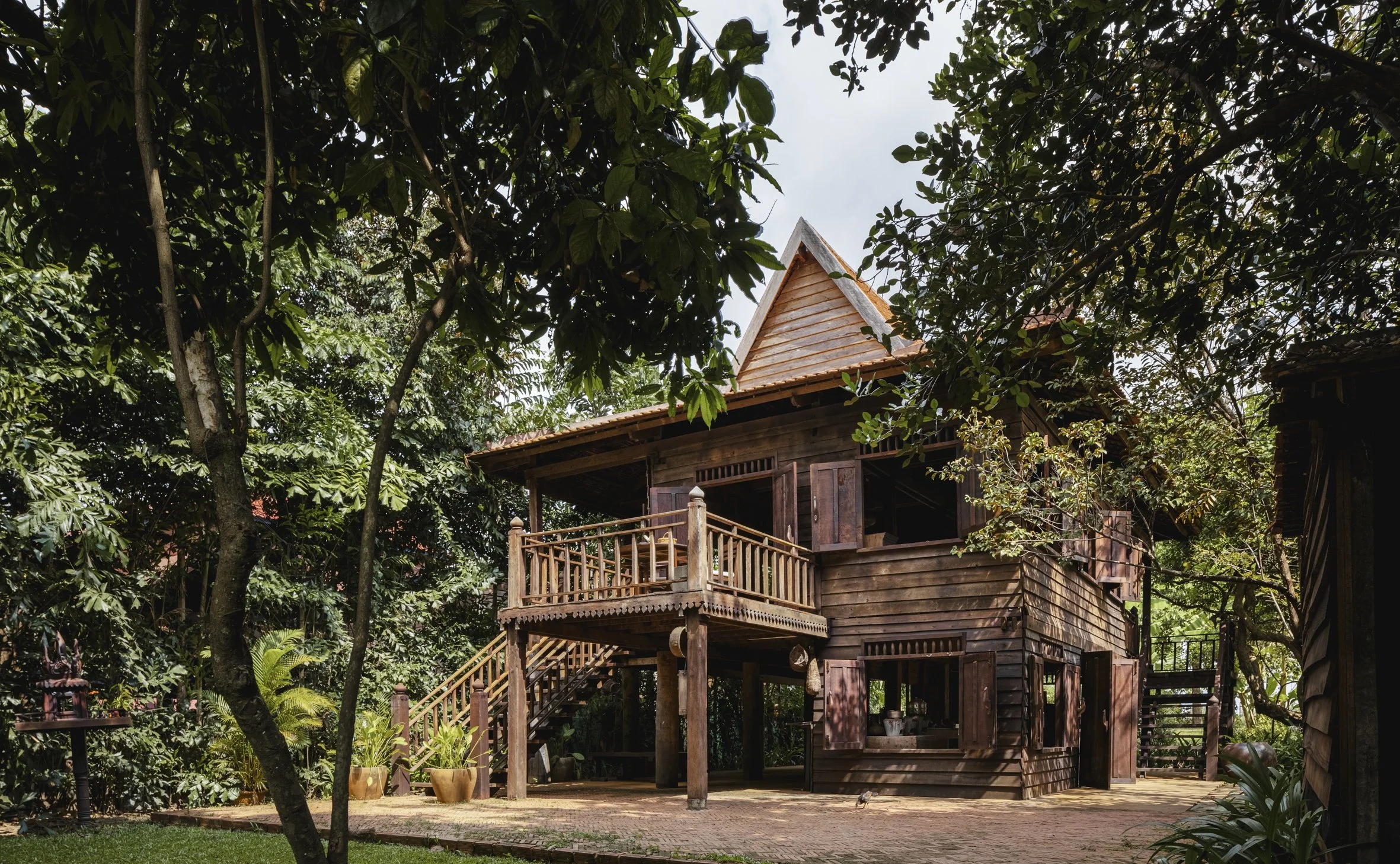 23-khmer-village-house-among-tropical-trees.jpg