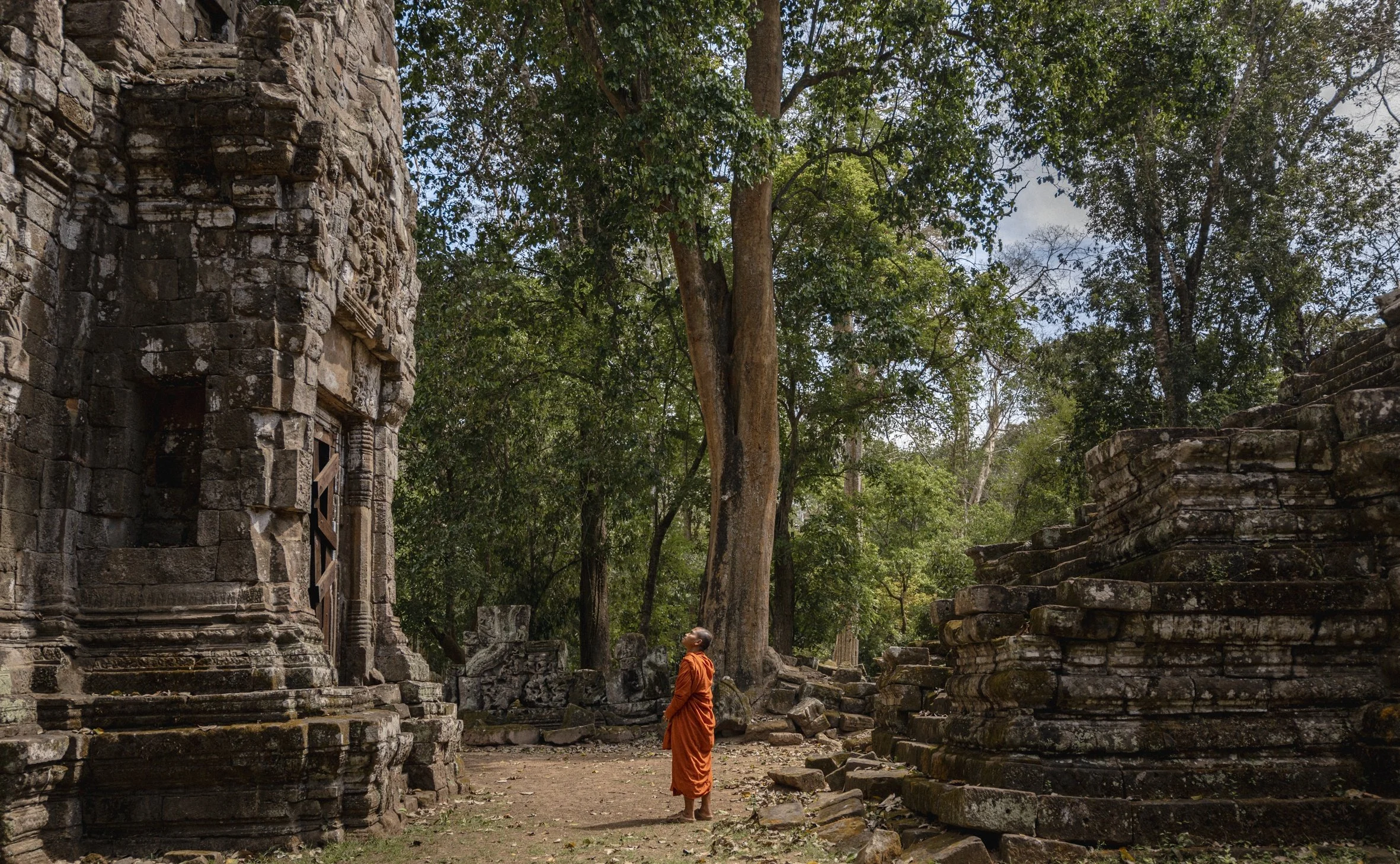 32-stone-temple-ruins-and-a-monk-in-the-angkor-landscape.jpg