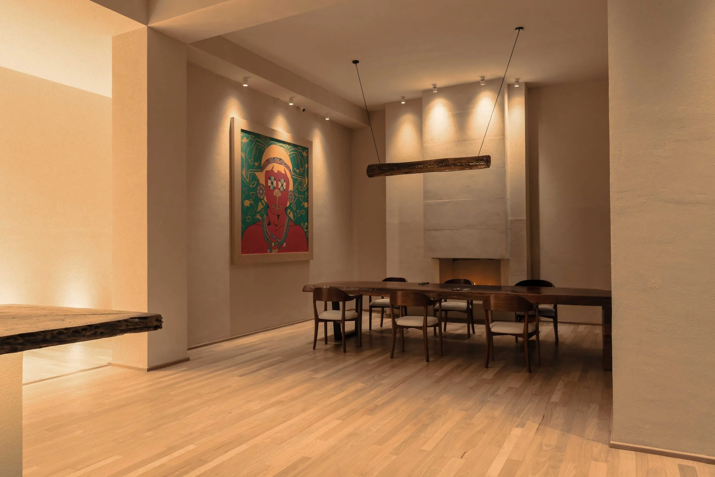 07-dining-table-beside-a-fireplace-and-colorful-artwork.jpg
