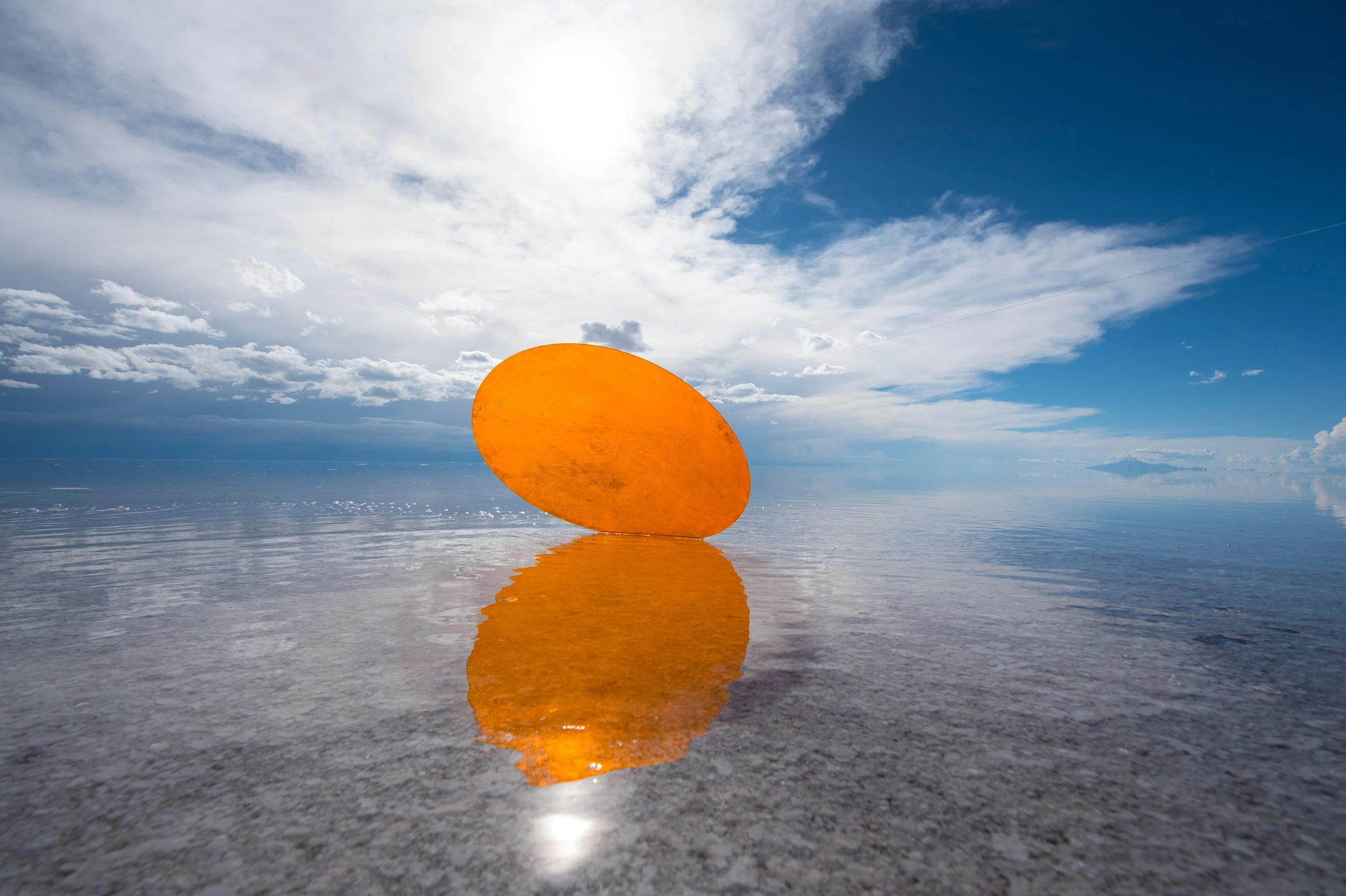 26-yellow-sculptural-form-against-a-reflective-salt-flat-landscape.jpg