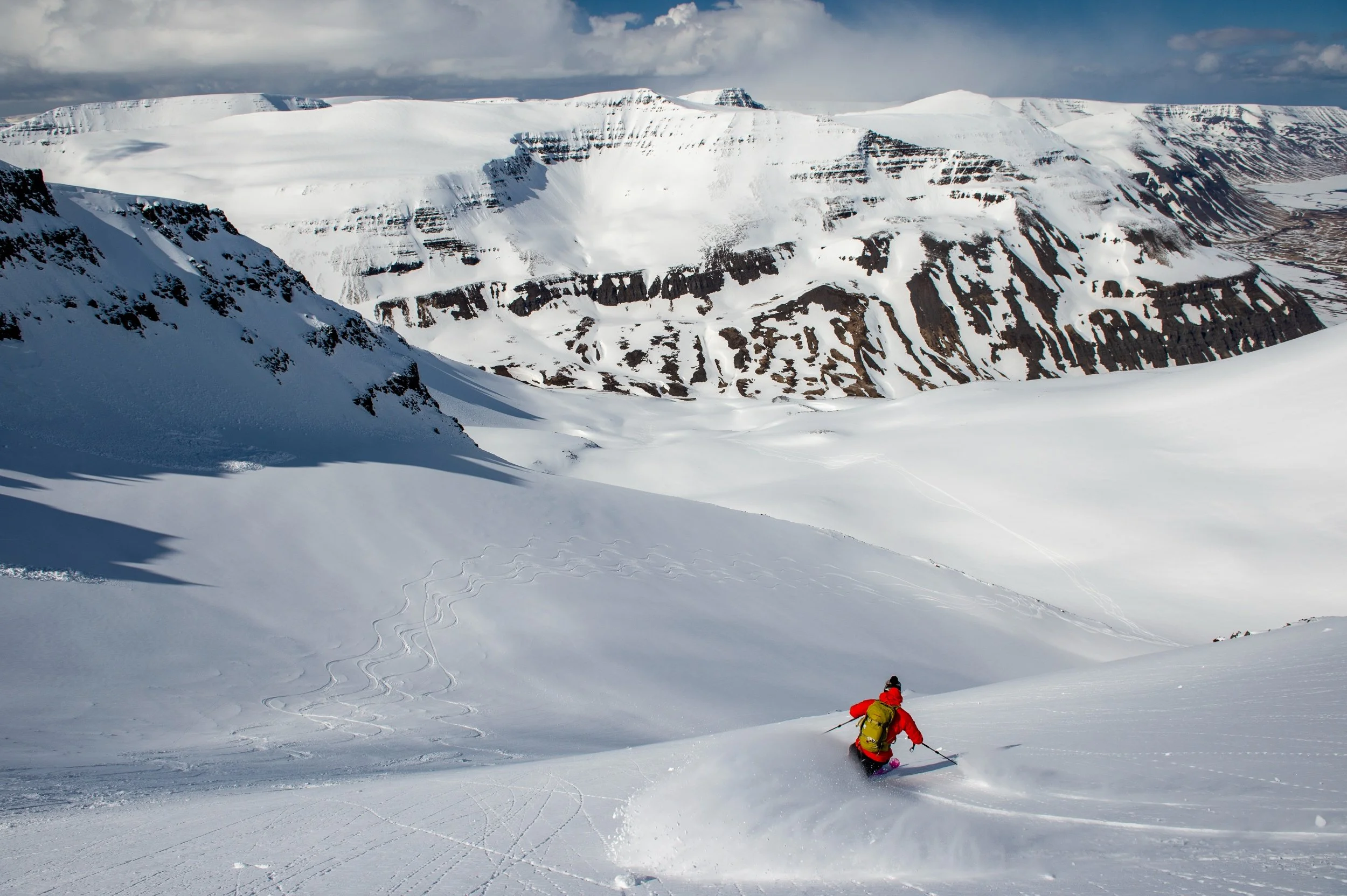 25-skier-descending-a-snowy-mountain-slope.jpg