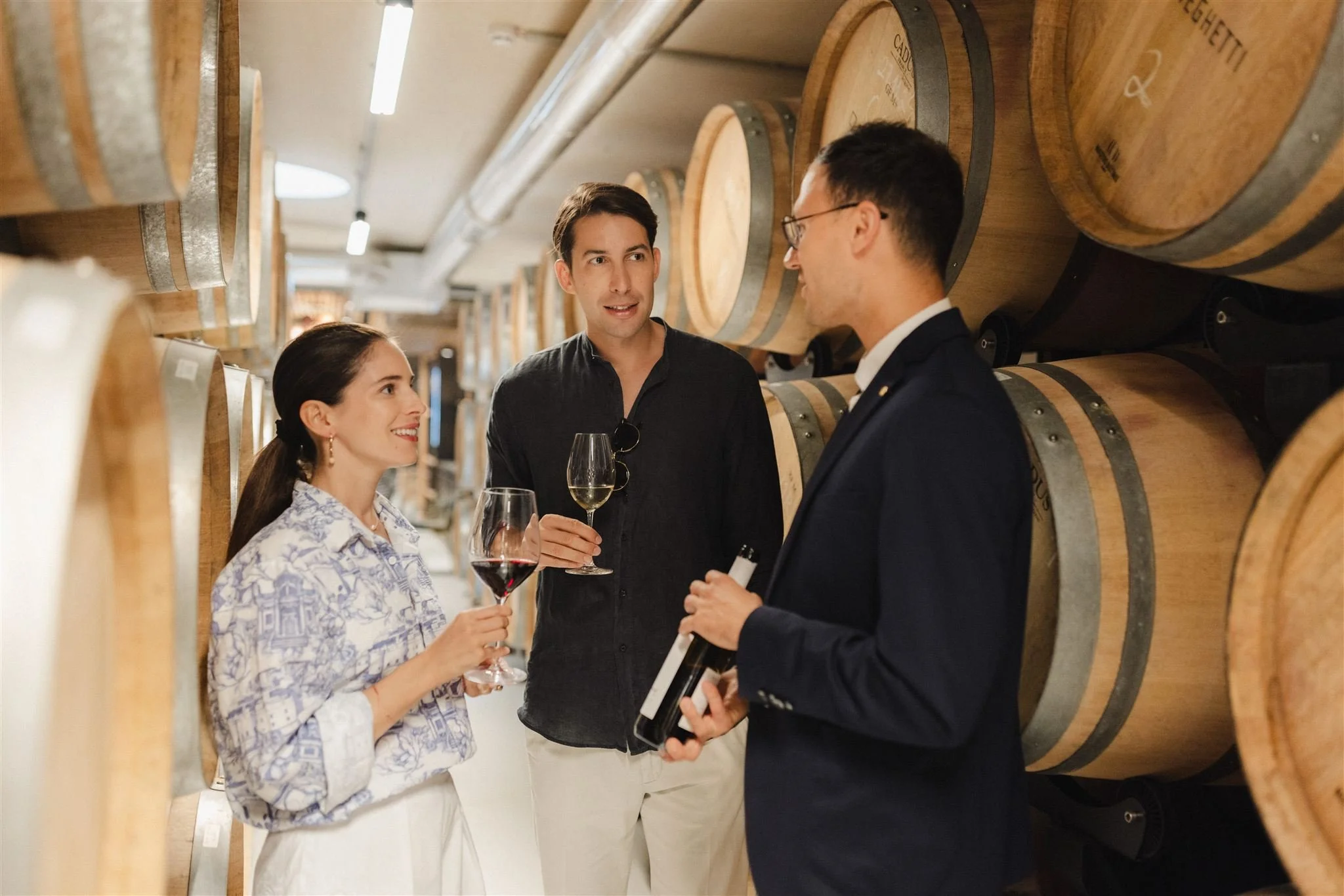 25-wine-tasting-beside-barrels-in-the-cellar.jpg