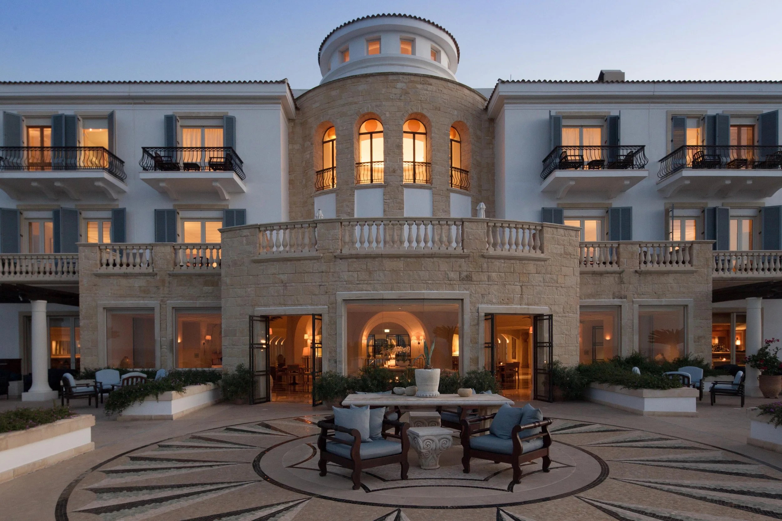 02-Anassa-Main-Facade-and-Courtyard-at-Dusk.jpg