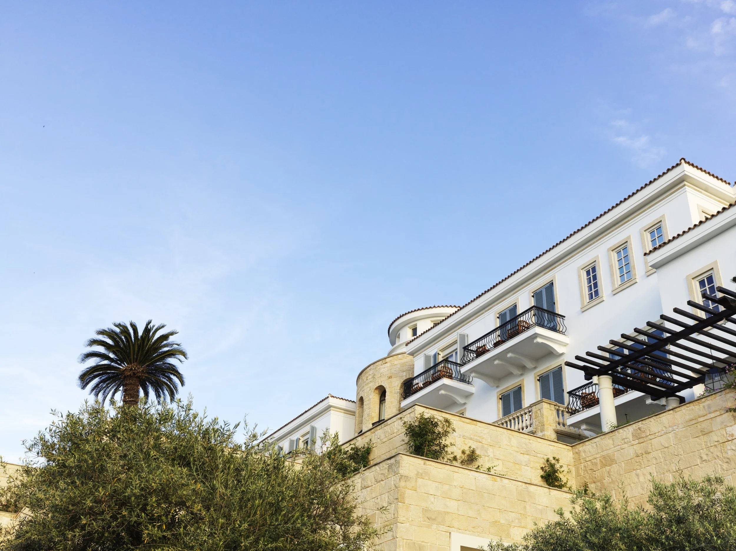 03-Anassa-White-Facade-and-Landscaped-Slope.jpg