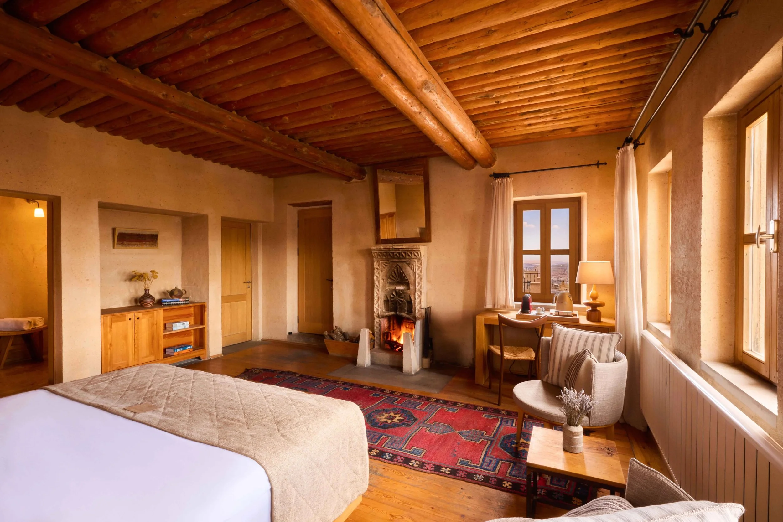 03-Deluxe-Room-Bedroom-Wood-Ceiling-and-Stone-Walls.jpg