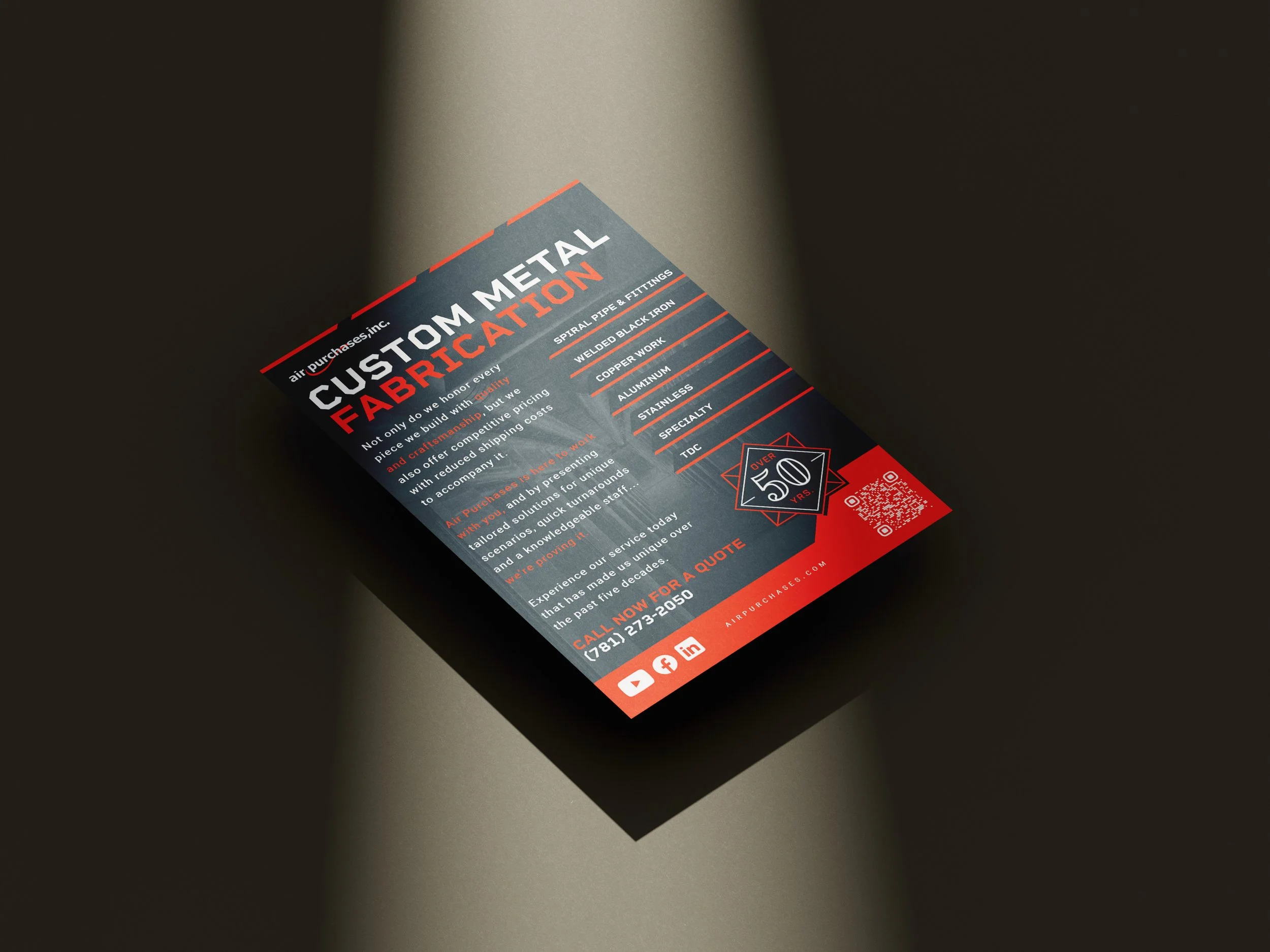 Close-up of a business flyer titled 'Custom Metal Fabrication' with contact information and social media icons at the bottom.