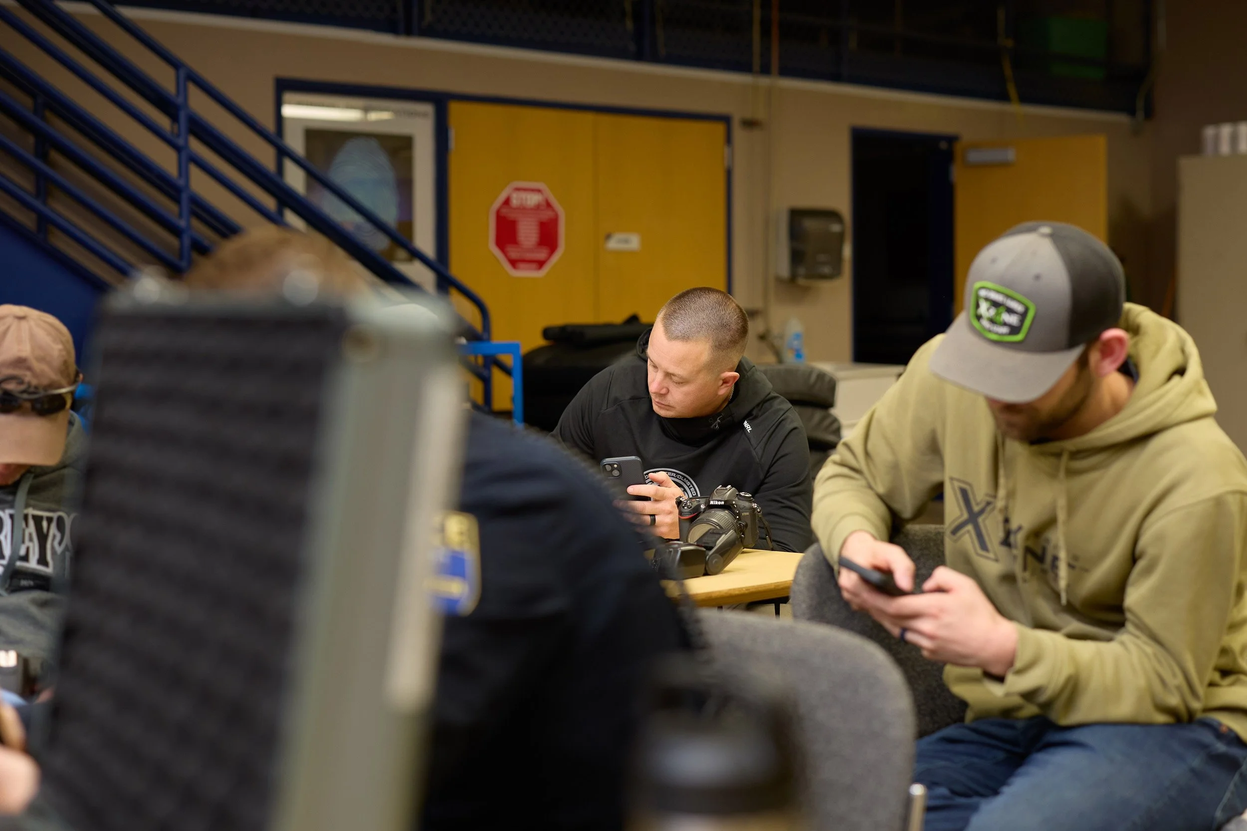 Rochester police officers taking notes during a professional photography class on vehicle and crash documentation