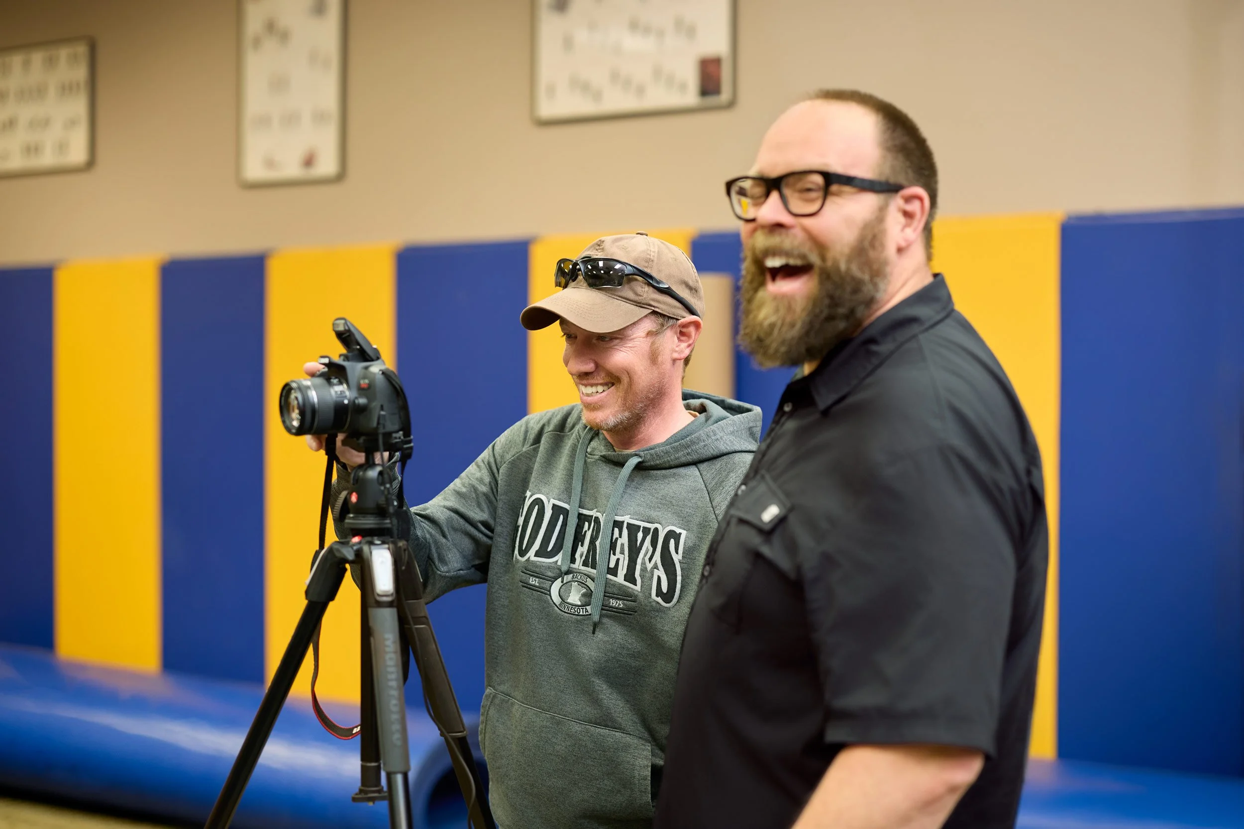 Scott Schoeberl of Olive Juice Studios laughing with a Rochester police officer during a crime scene photography class at RCTC