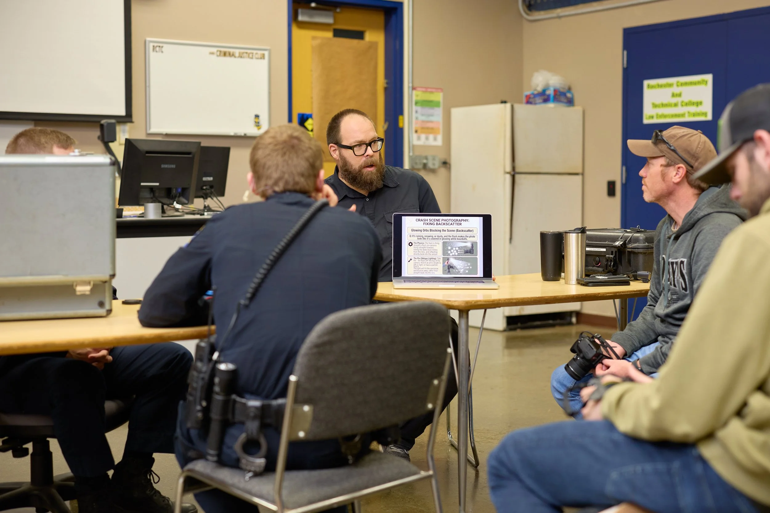 Scott Schoeberl explaining how to fix backscatter in low-light photography during a forensic training course at RCTC