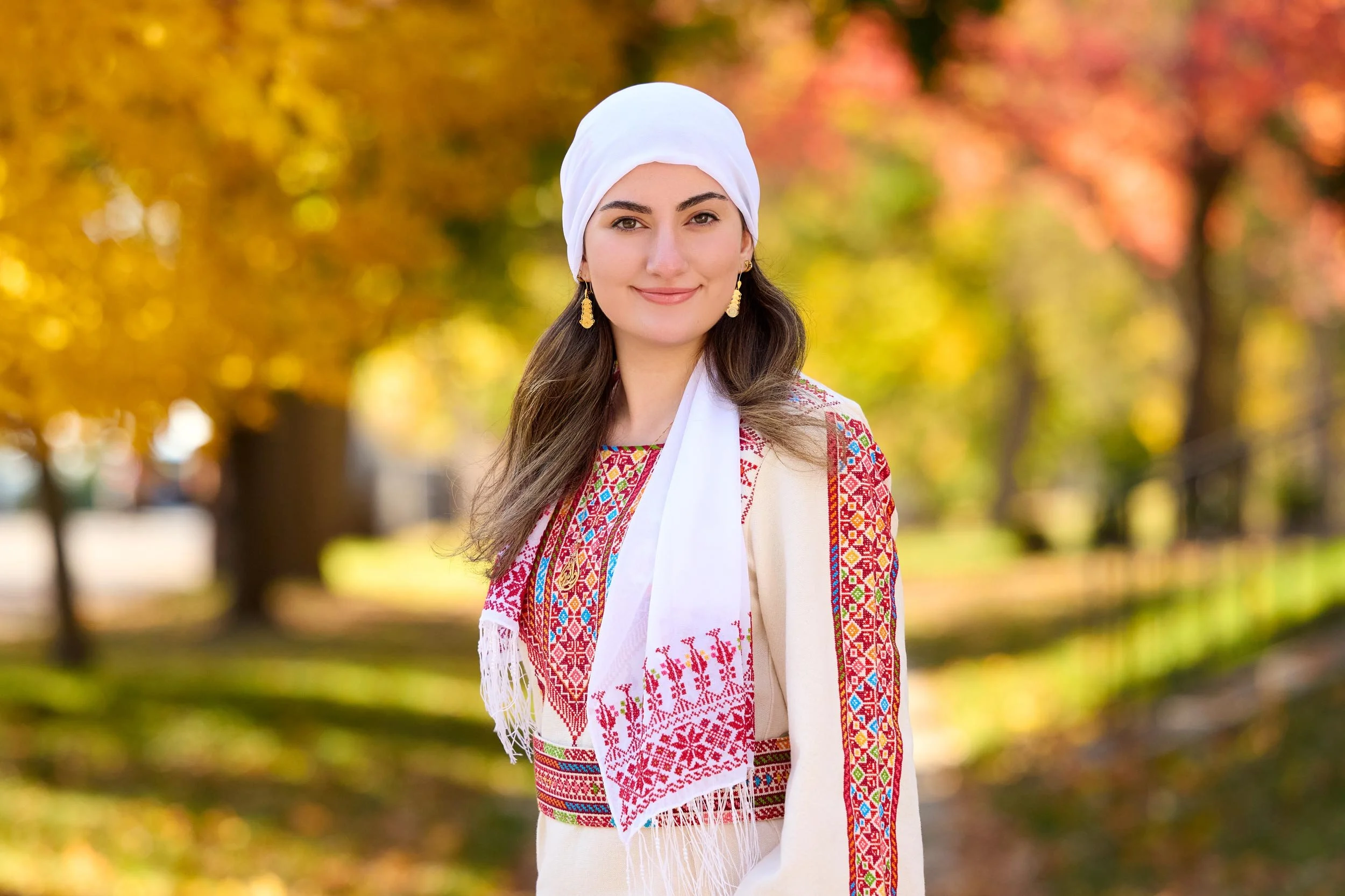 High school senior wears traditional dress and head scarf to honor Palestinian heritage.