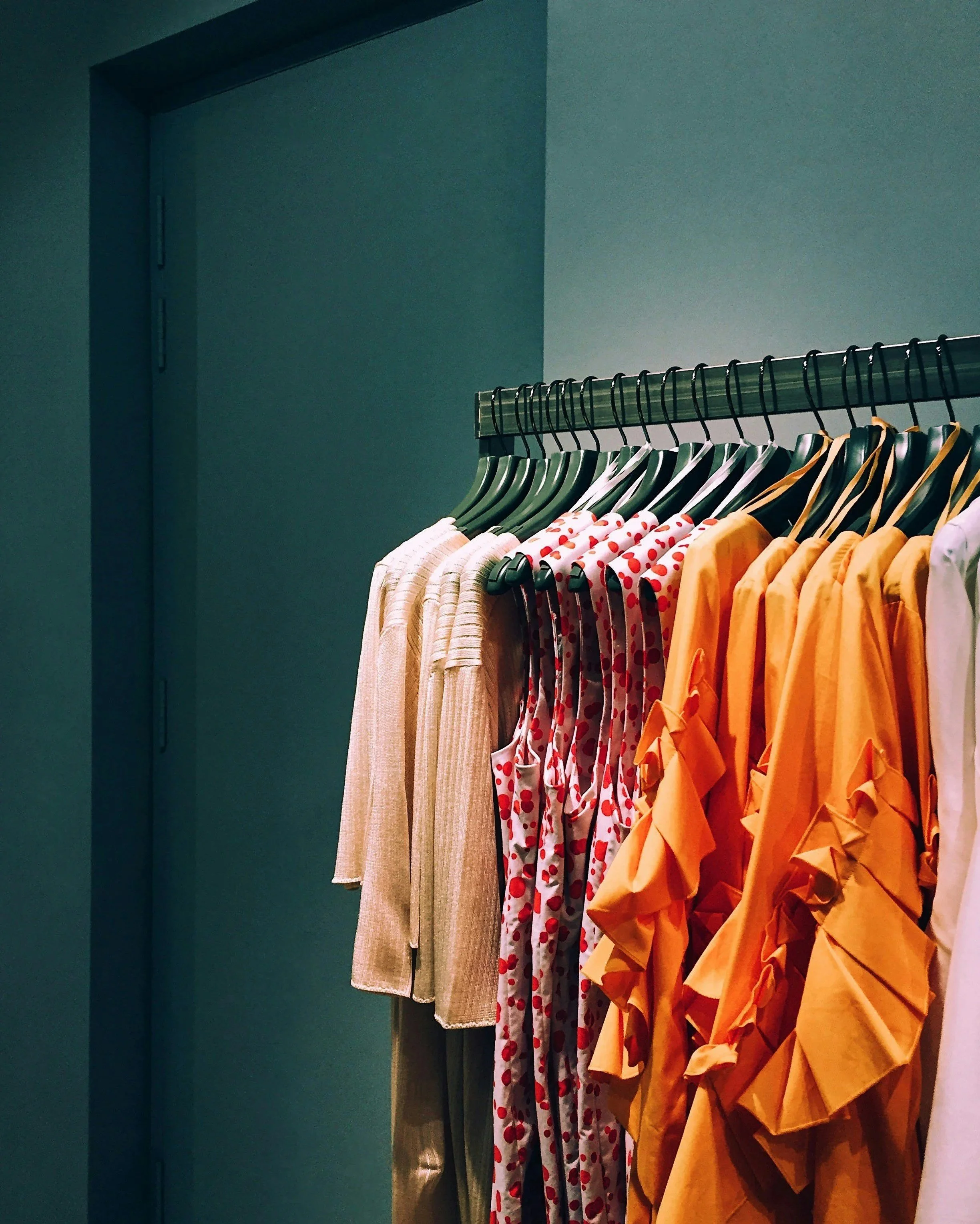 Colourful clothes on hanging rack