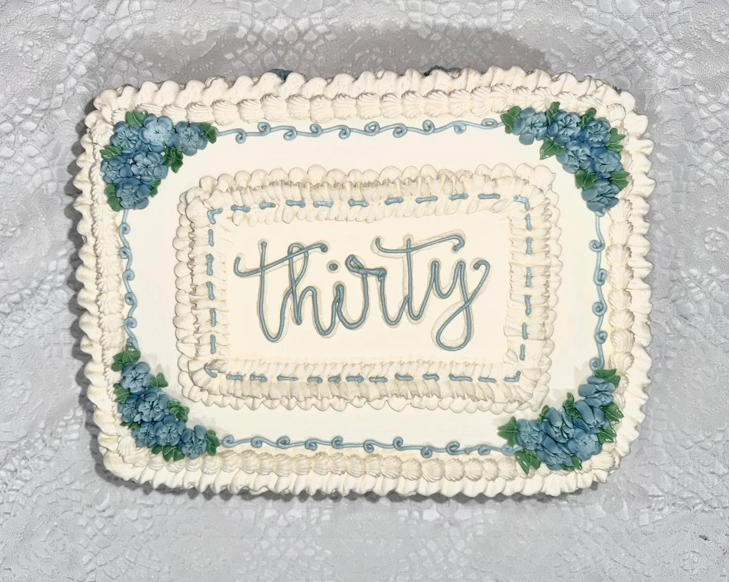 Blackberry Lemon Vintage sheet cake with a flower moment for a thirtieth birthday! // Blackberry cake, filled with Lemon Curd, and covered in Lemon Buttercream. Our blackberry cake has become a crowd favorite because it&rsquo;s the perfect mix of swe