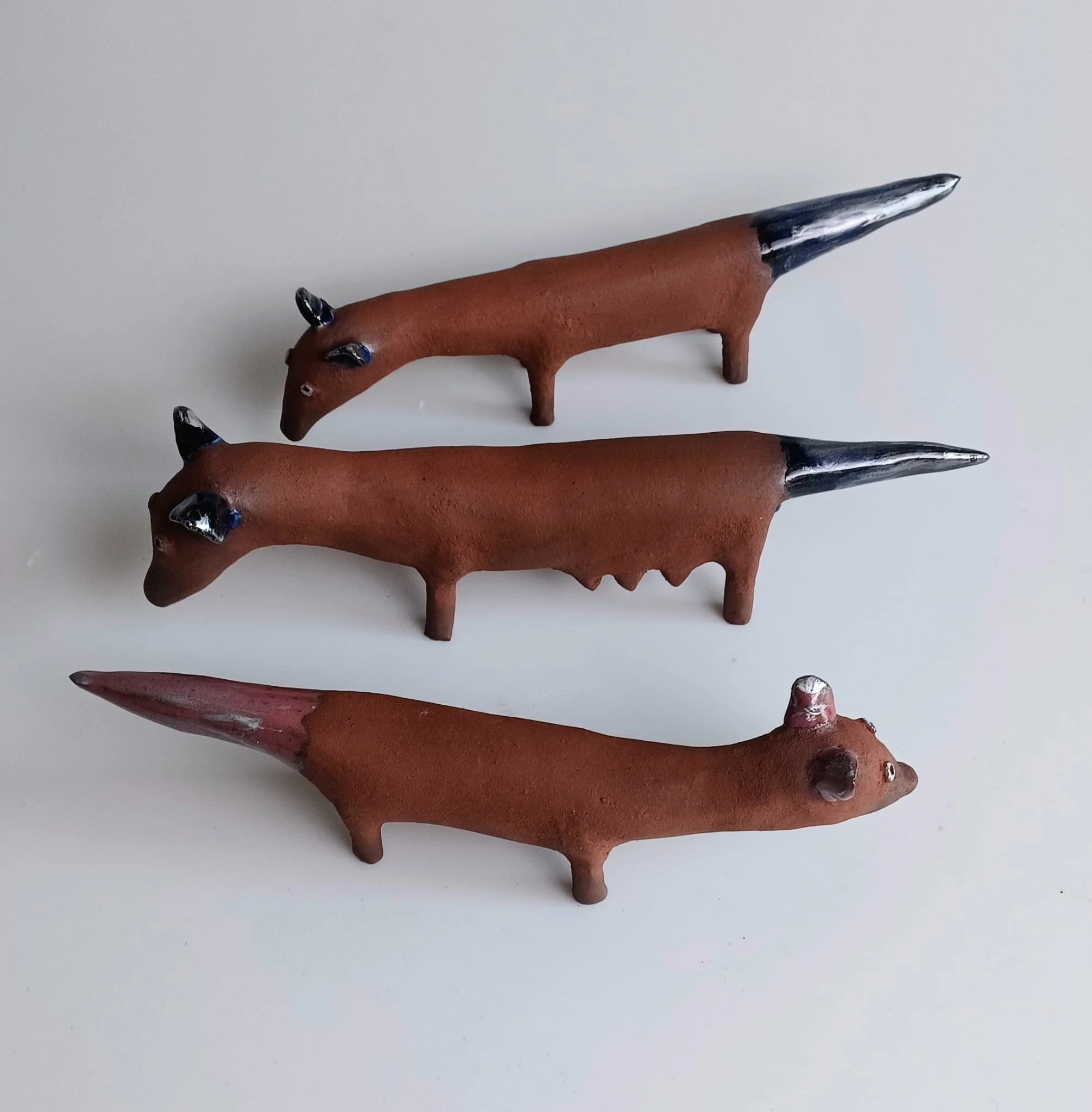 Vixens.  
Stoneware, glaze, lustre